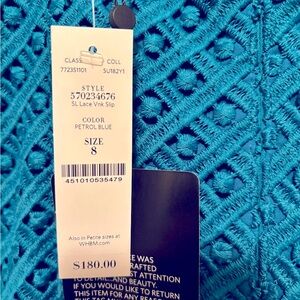 Fitted knee length dress. Polyester fabric with lining. Color turquoise blue.